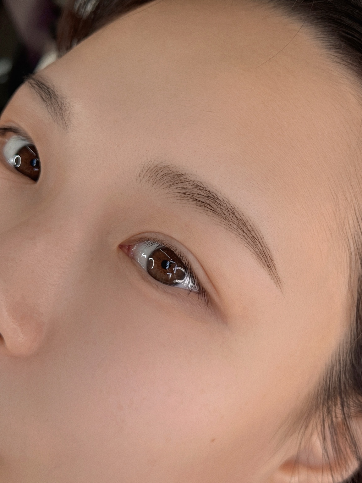 CLEO eyebrow work viewed from a side angle