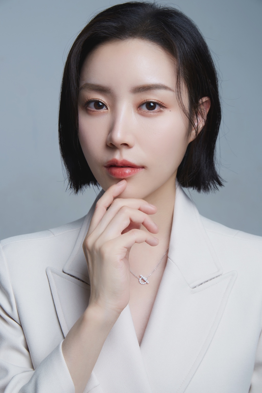 Sunha Kim, CLEO director, in a white jacket